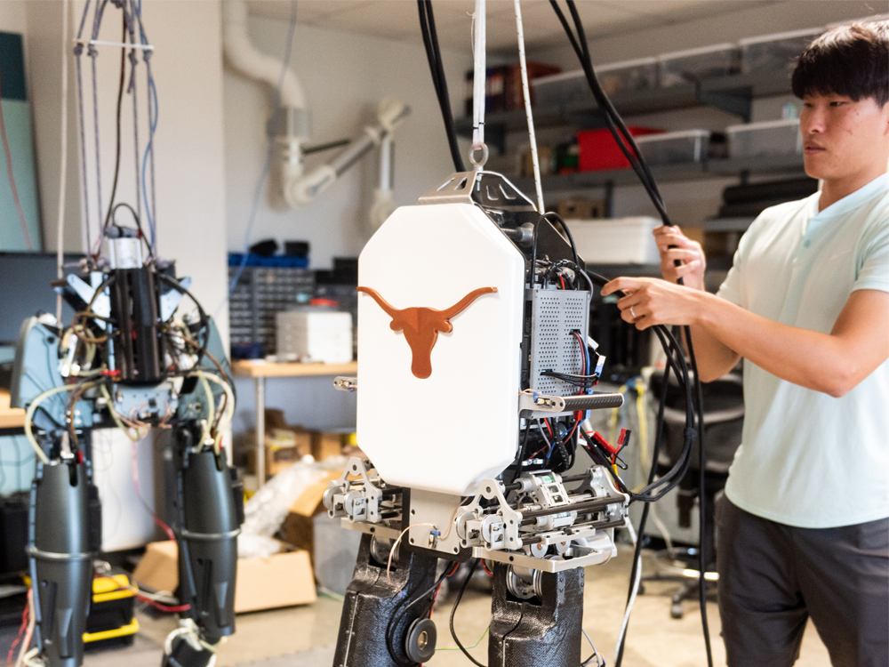 one student working on tall robot