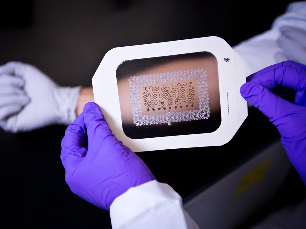 thin microchip being put on arm