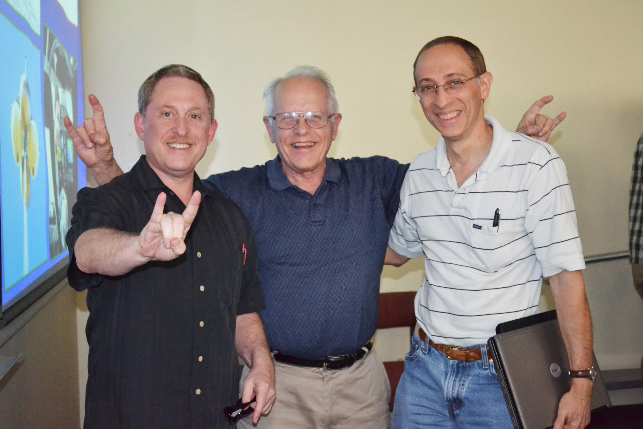 Alumnus Alan Stern smiling in classroom with professors Wallace Fowler and David Golstein.