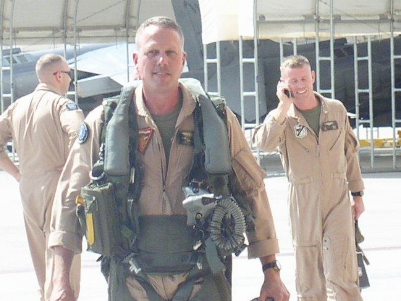 Glenn Hoppe walking on military base in Army fatigues.