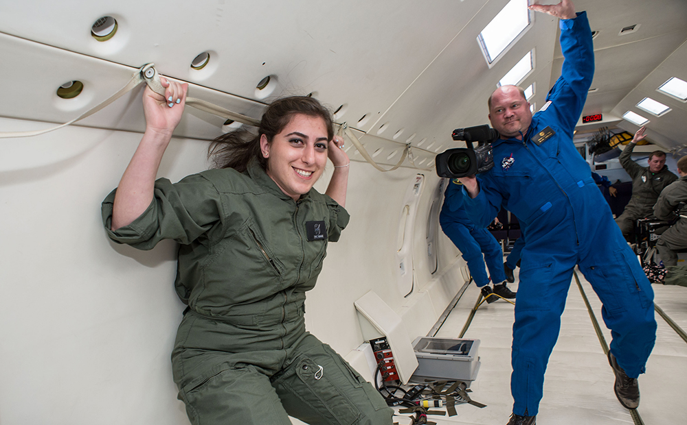 Patil Tabanian smiling while floating in space microgravity simulation.