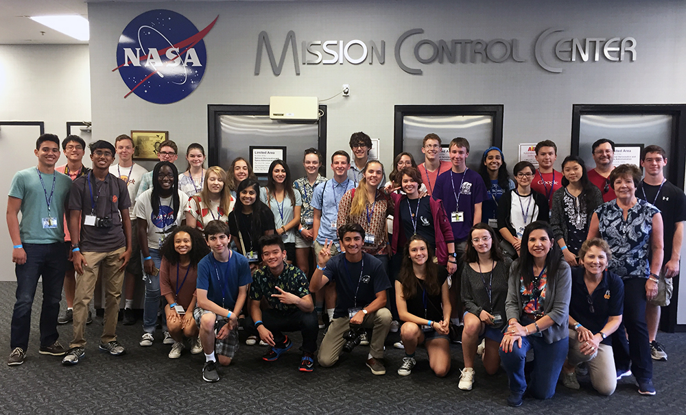 NASA SEES group smiling for photo under NASA logo.