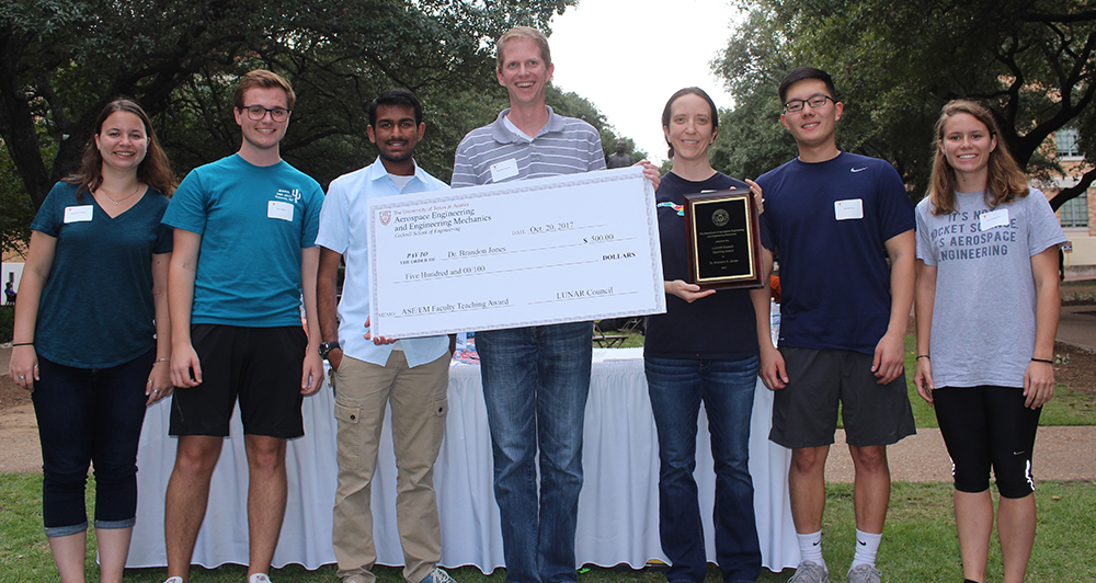 Brandon Jones with students presenting award photo