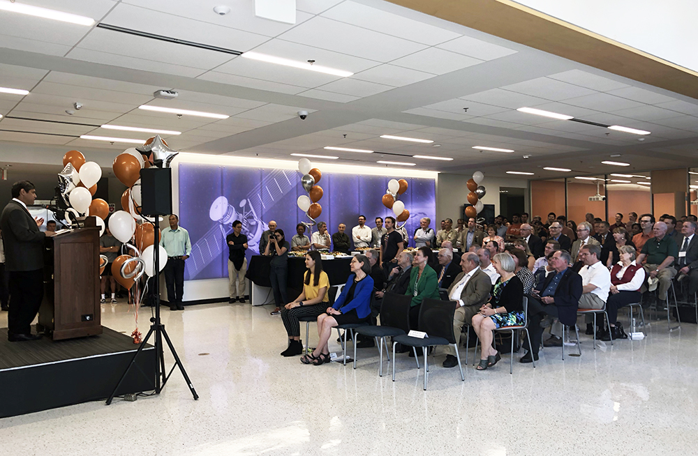 people sitting in chairs facing a man speaking at the clemens group grand opening ceremony