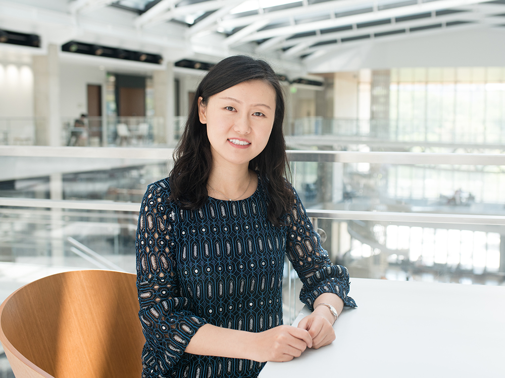 Texas Engineer Nanshu Lu smiling, sitting at table