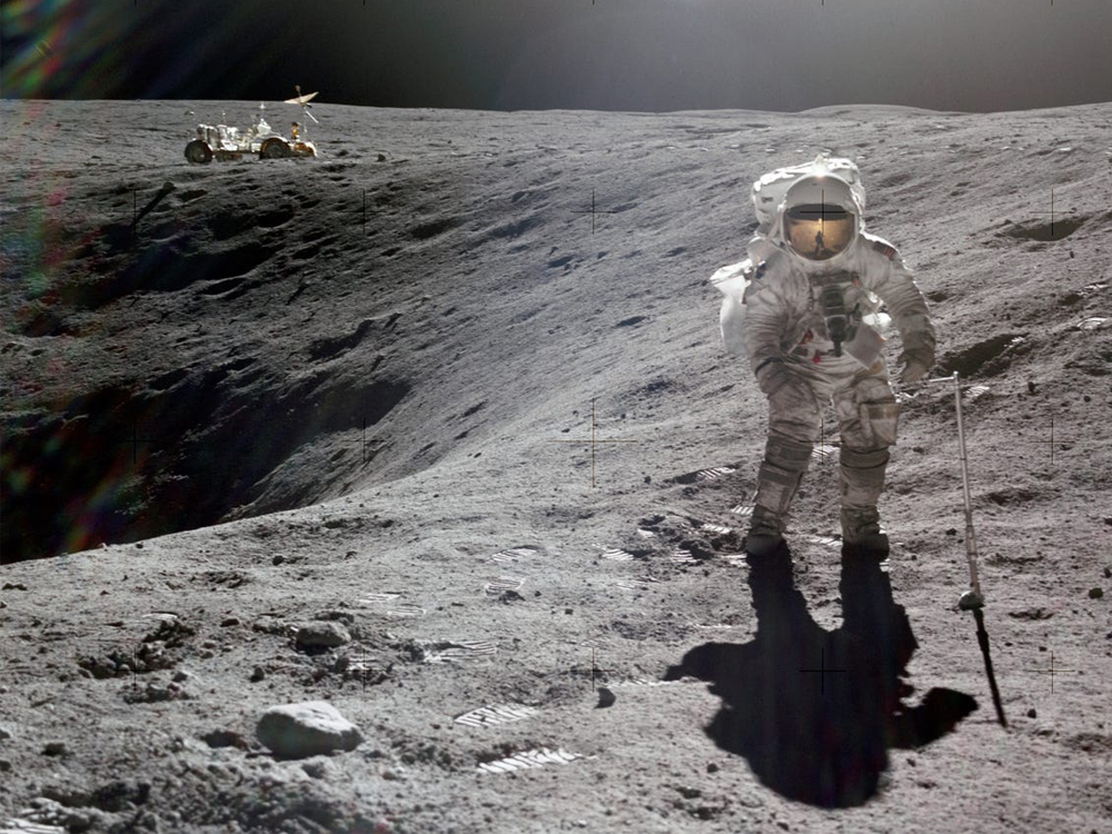 Astronaut in spacesuit walking on moon's surface.