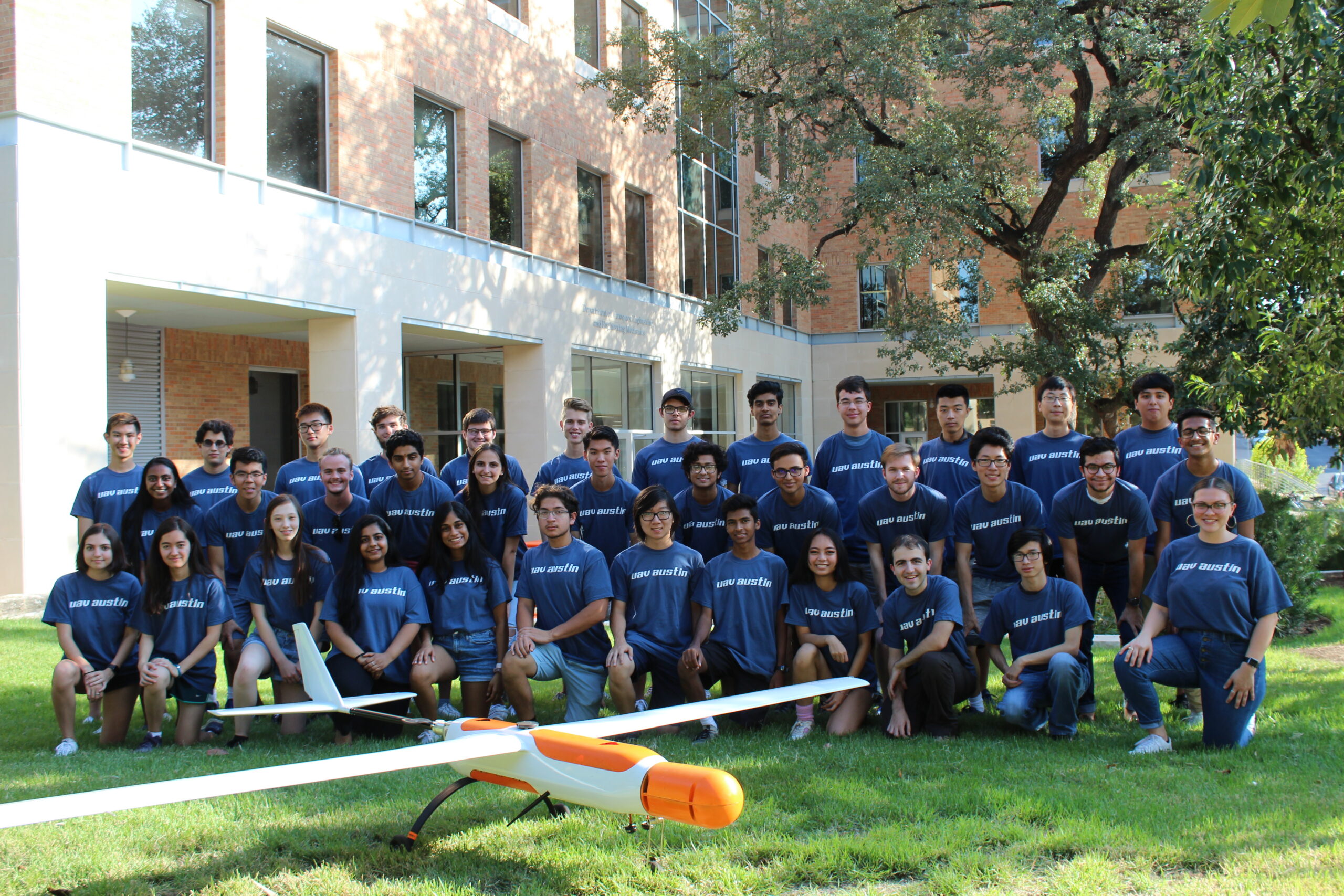 group photo of uav austin members with airplane
