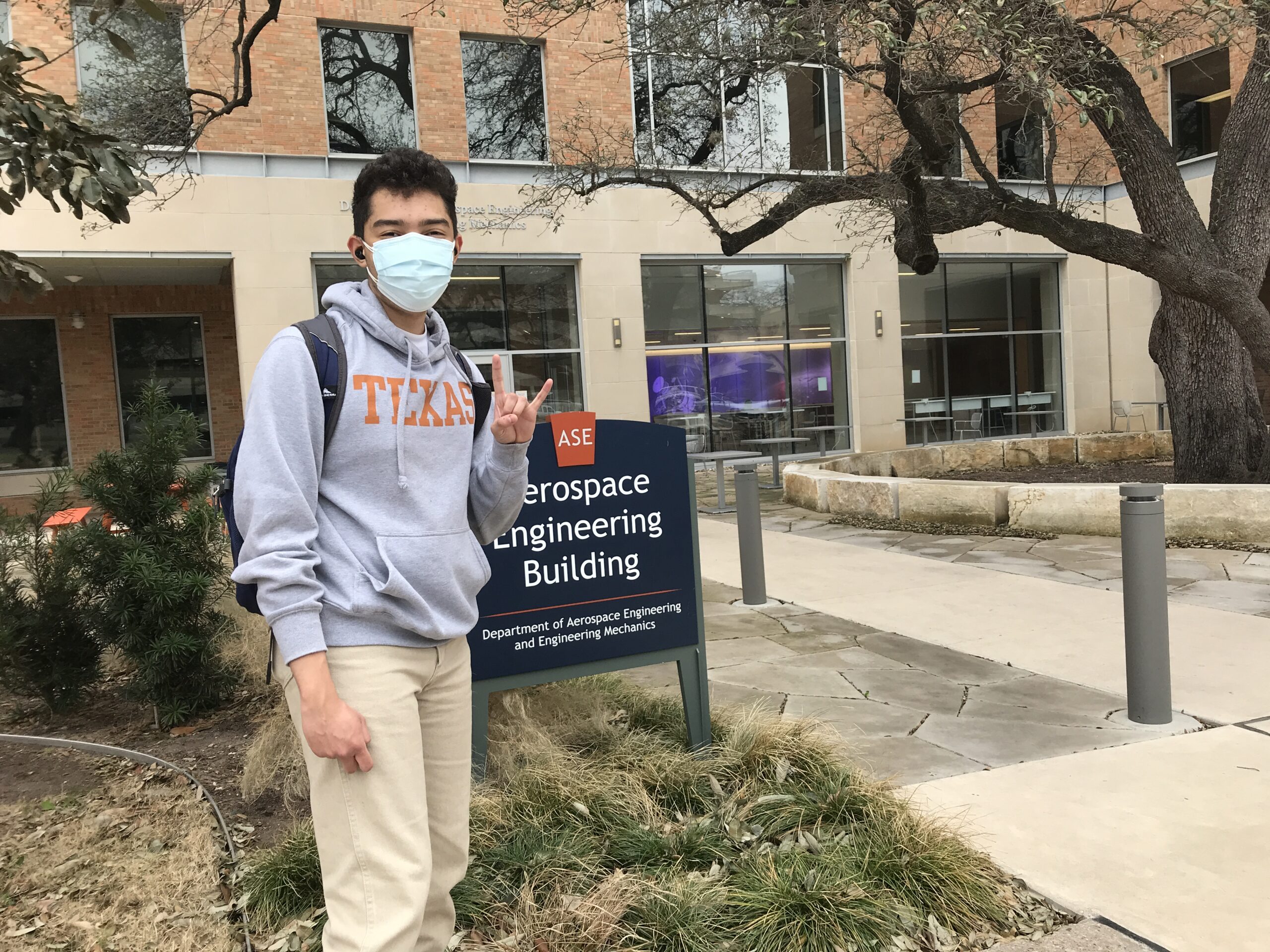 photo of joshua davis in front of ase bulidng