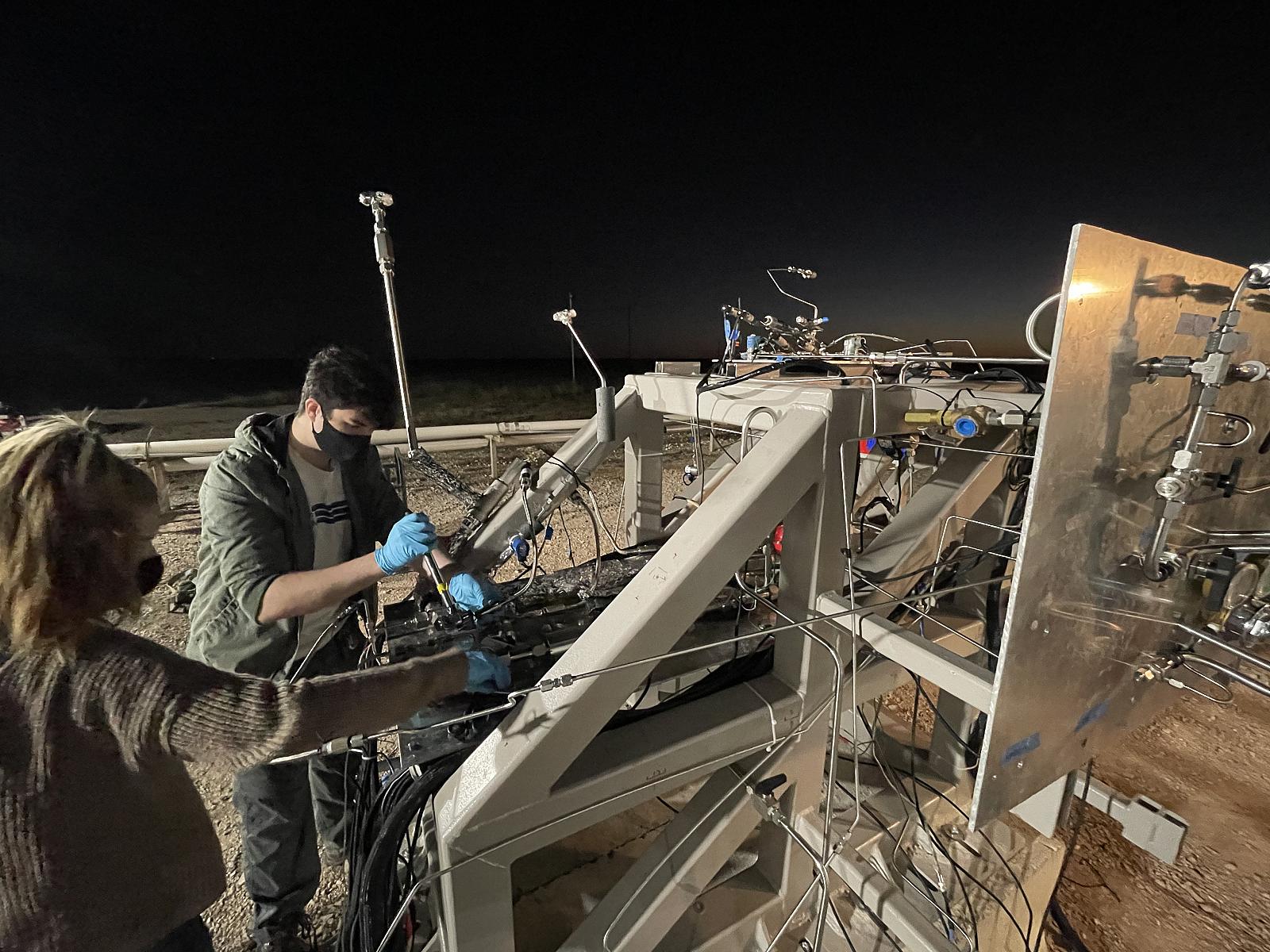 photo of students working on a rocket