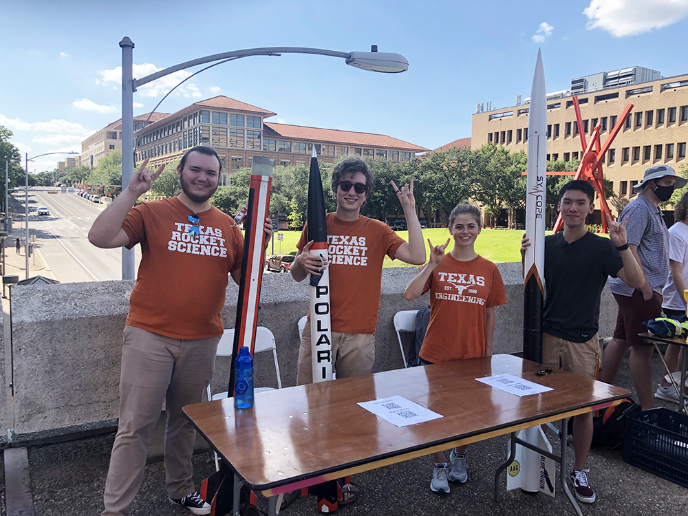 IRA team members smiling on bridge on UT Austin campus.
