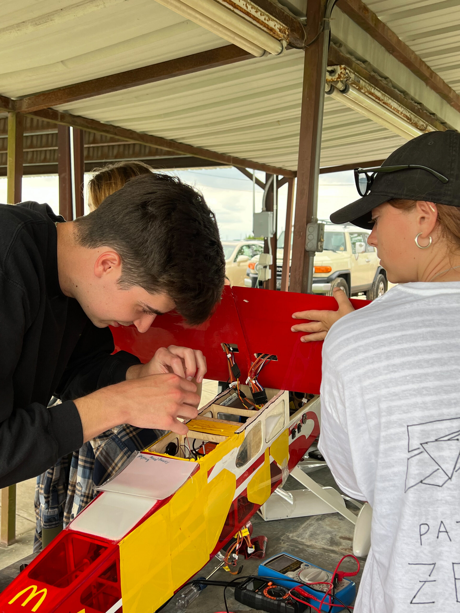 photo of students working on aircraft