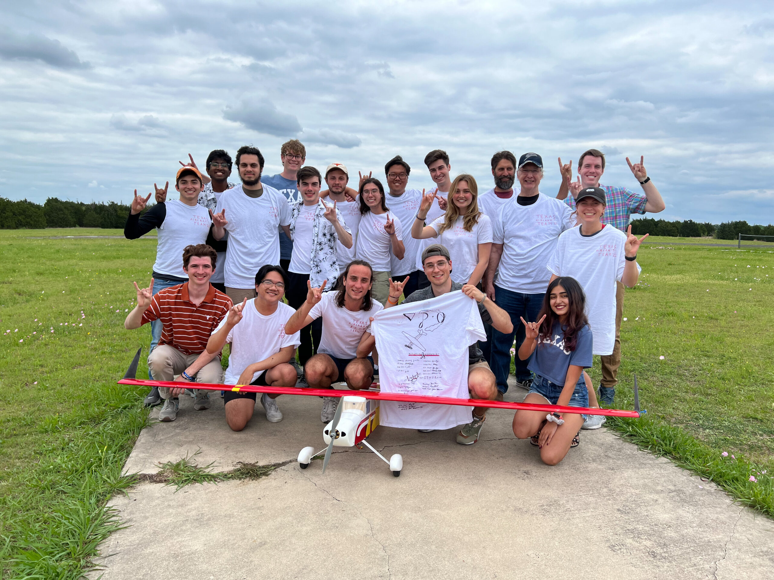 team photo of assuming incompressible aircraft design team with airplane