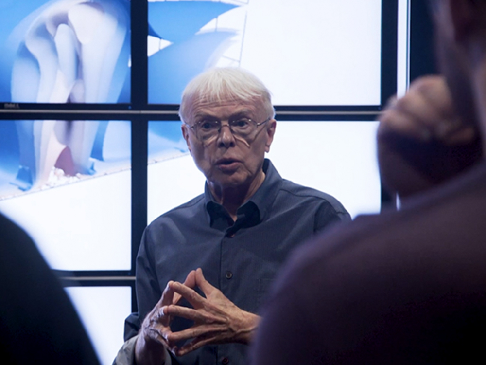 Thomas Hughes speaking with researchers in Visualization Lab.