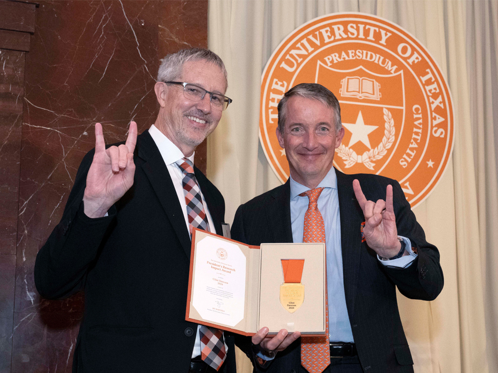 Clint Dawson receiving President's Research Impact Award with UT President Jay Hartzell.