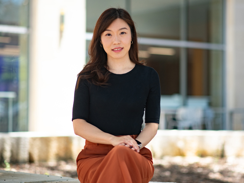 Hannah Lu sitting in front of ASE Building.