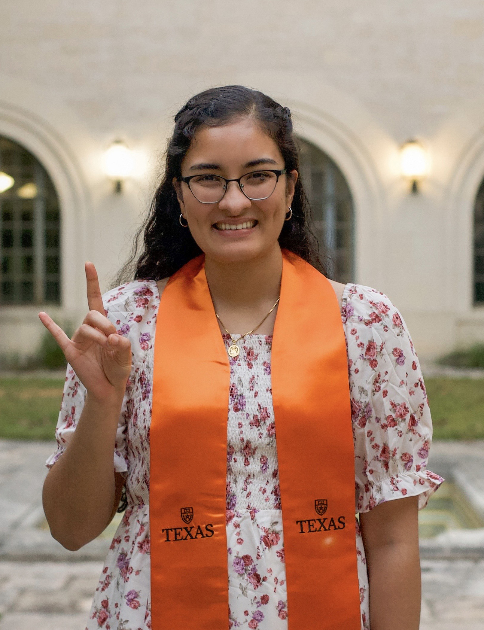 Texas Engineering student Sresha Ventrapragada smiling while wearing graduation regalia