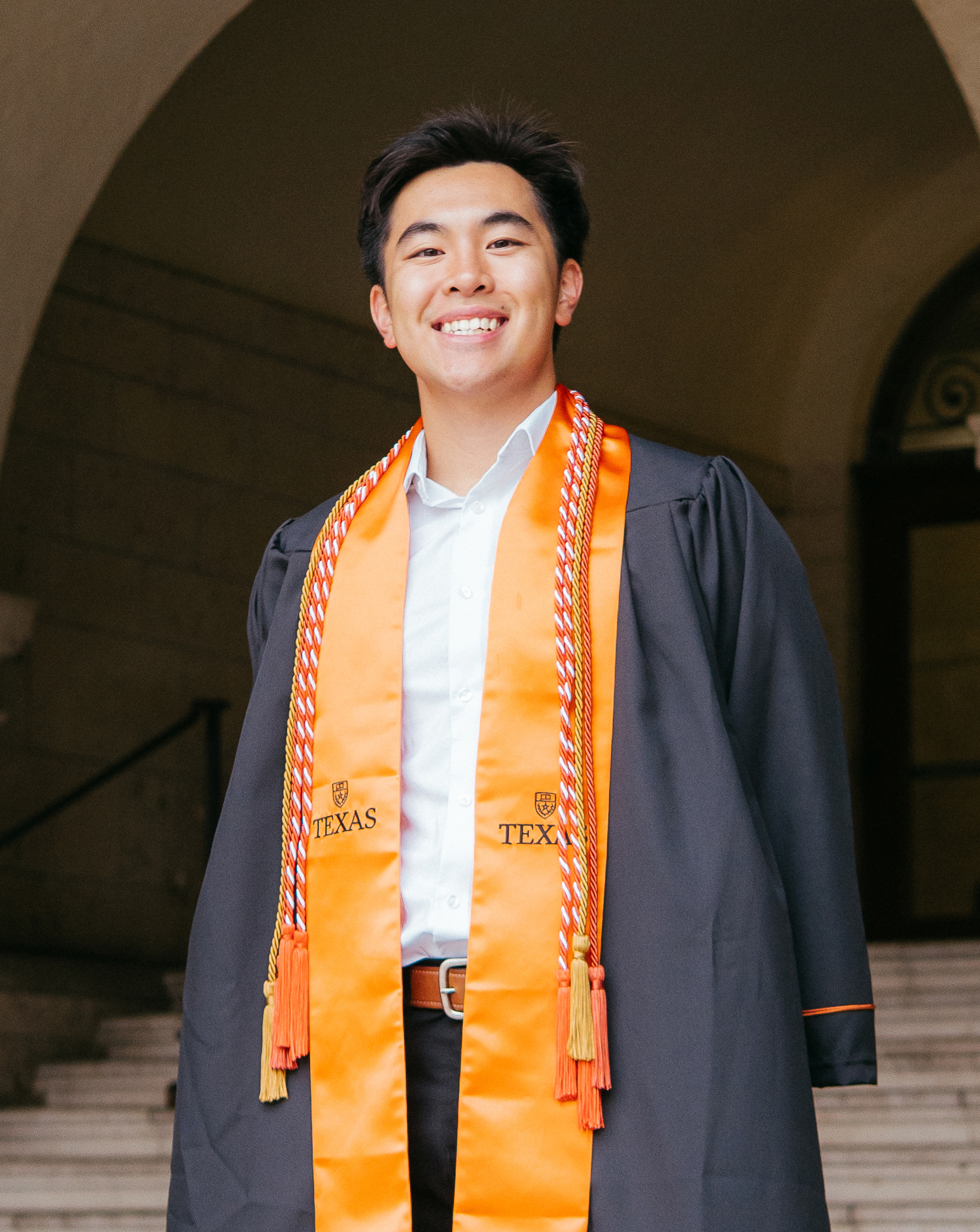 Texas Engineering student Jeremiah "Jerri" Do smiling while wearing graduation regalia