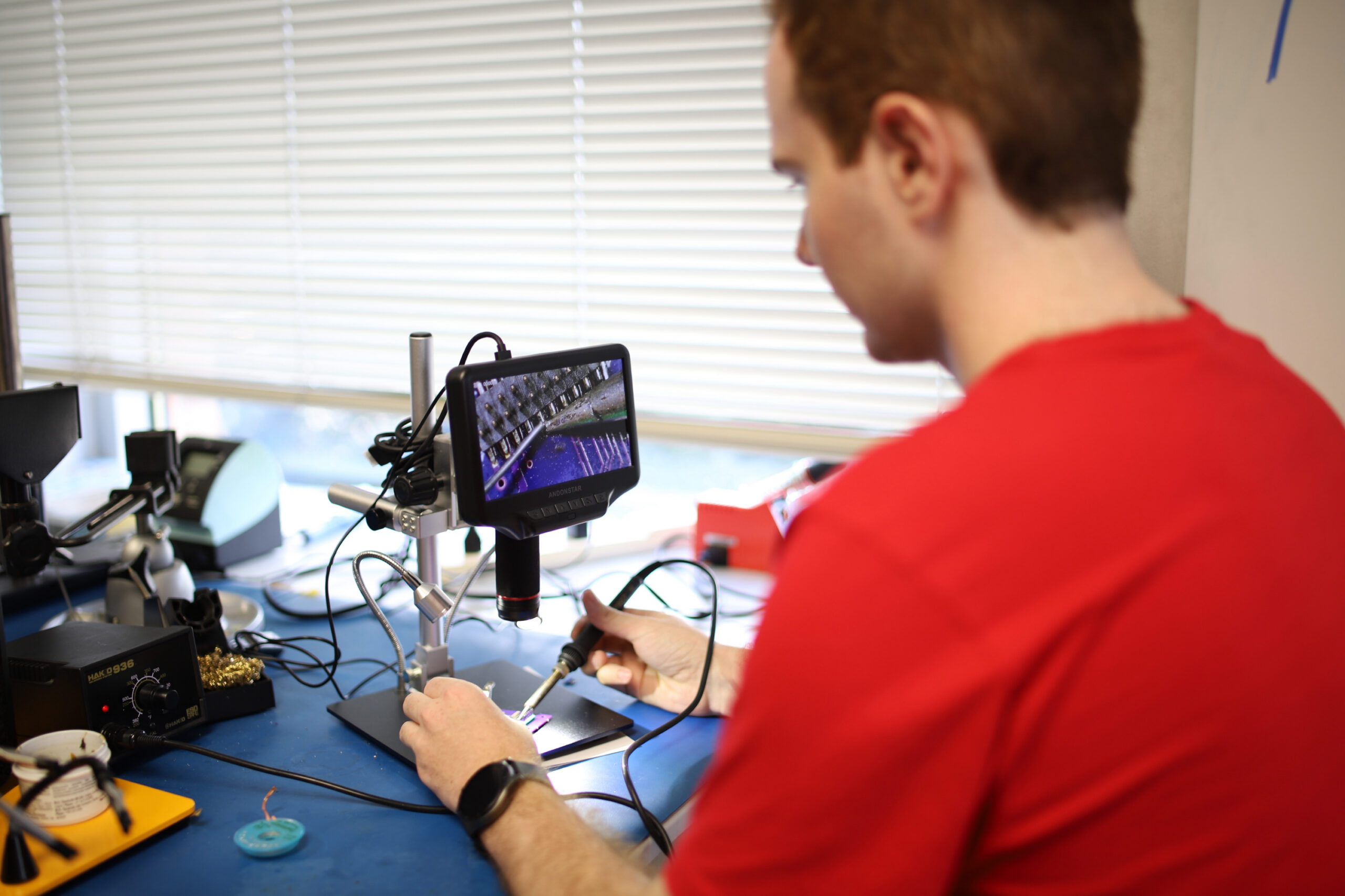 student working on satellite hardware