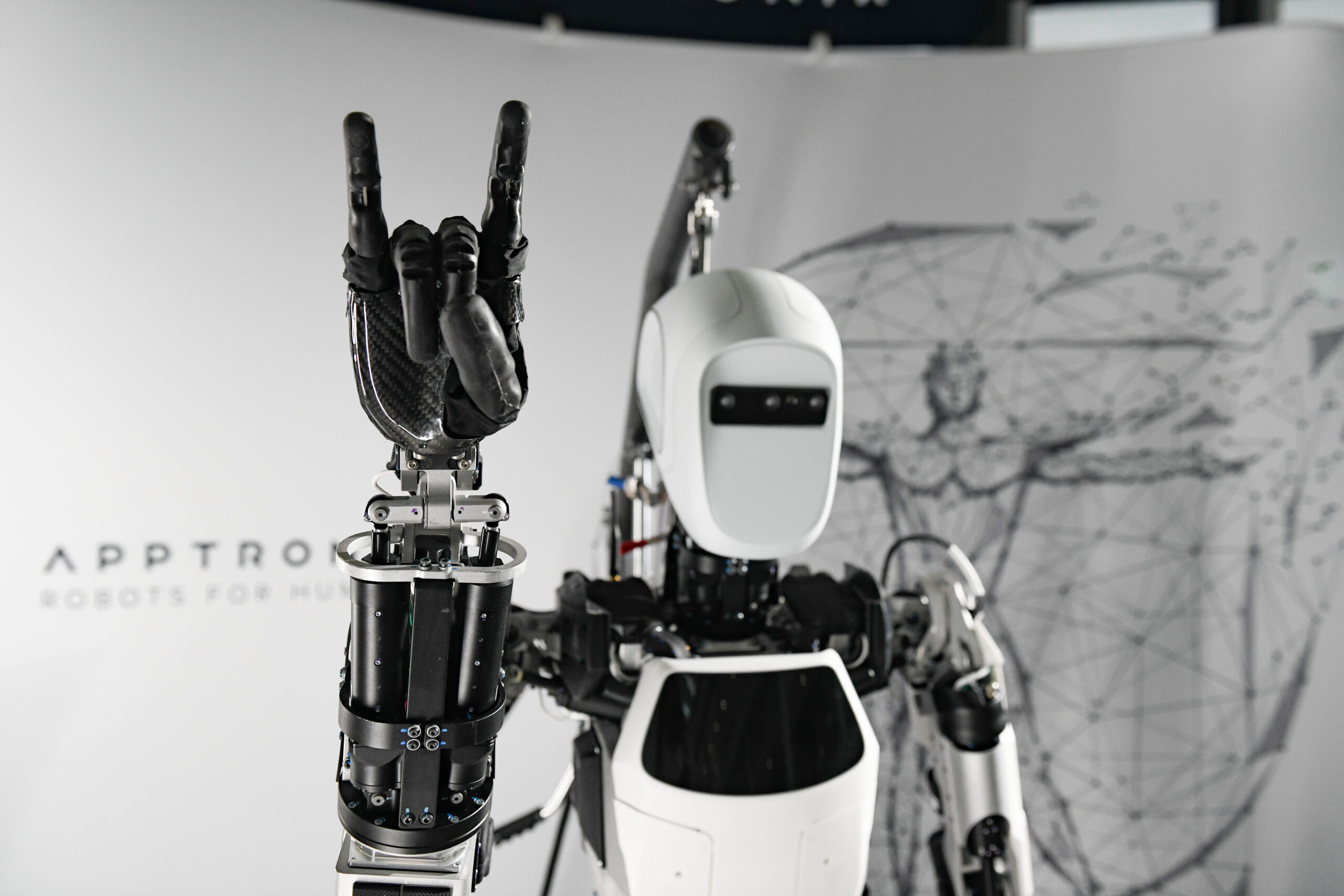 Apptronik robot doing hook'em horns hand gesture