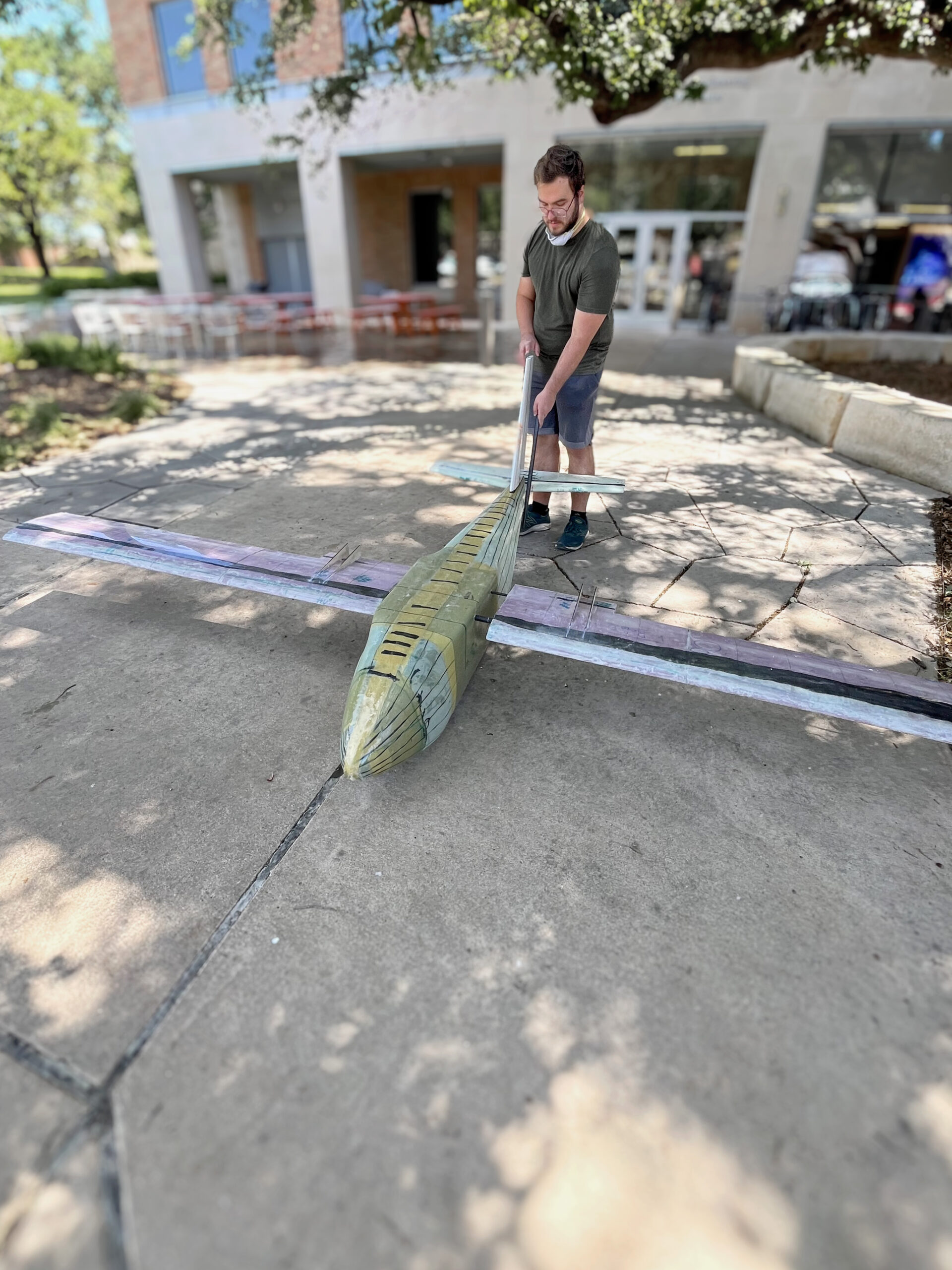 Andrew Doty standing next to drone prototype