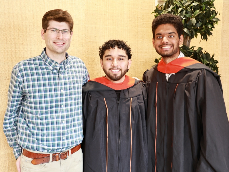 David Fridovich-Keil smiling with graduates Antonio Jimenez and Atharva Kalamkar.