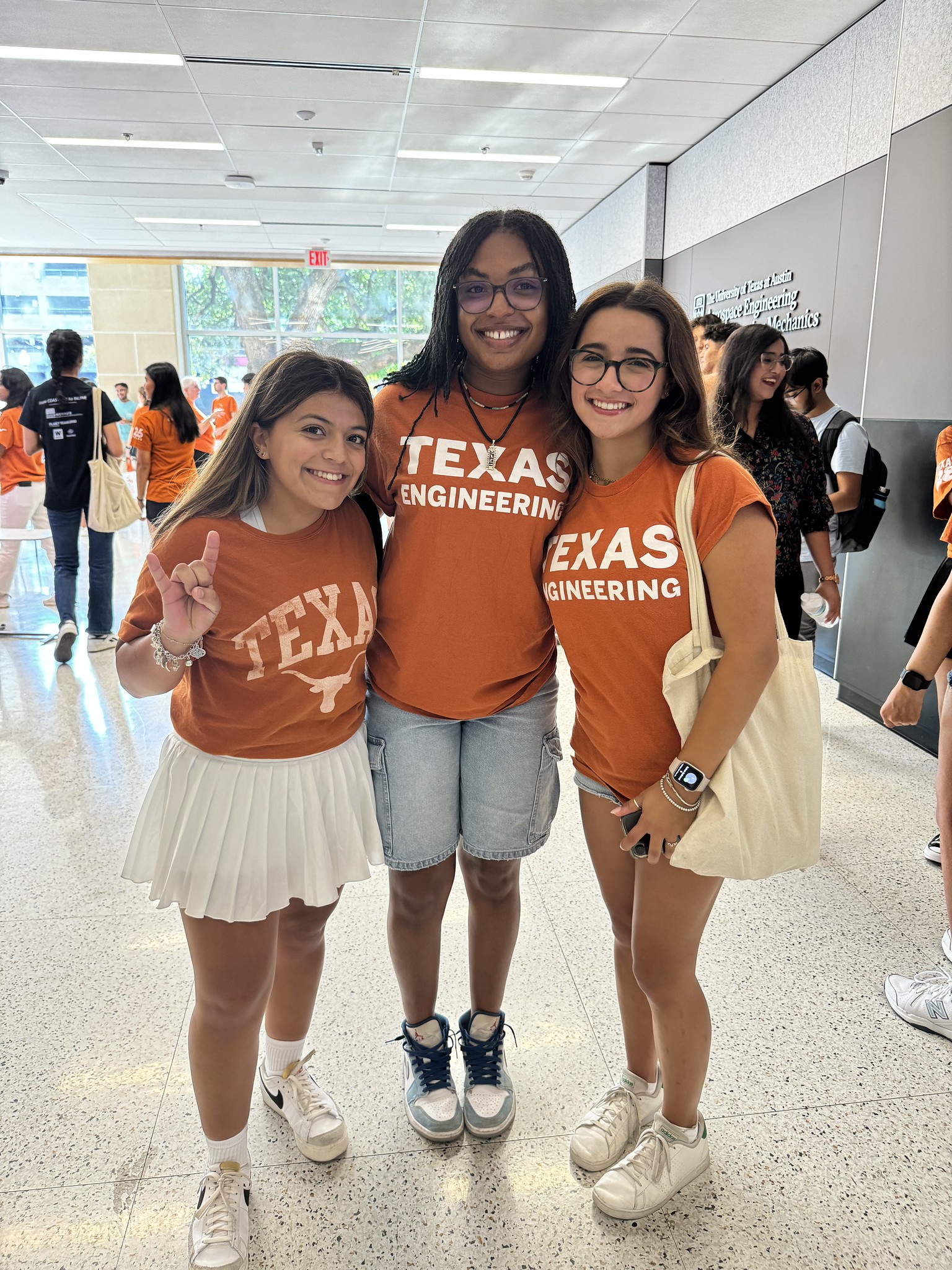 ASE/EM students smiling together during Gone to Engineering event while wearing Texas Engineering t-shirts.