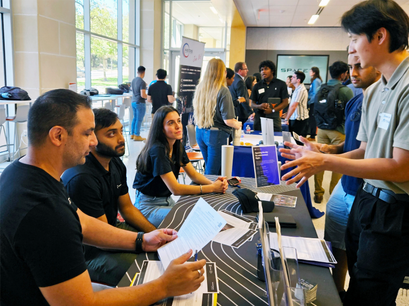 Students talking to table of industry professionals at Industry Open House event.