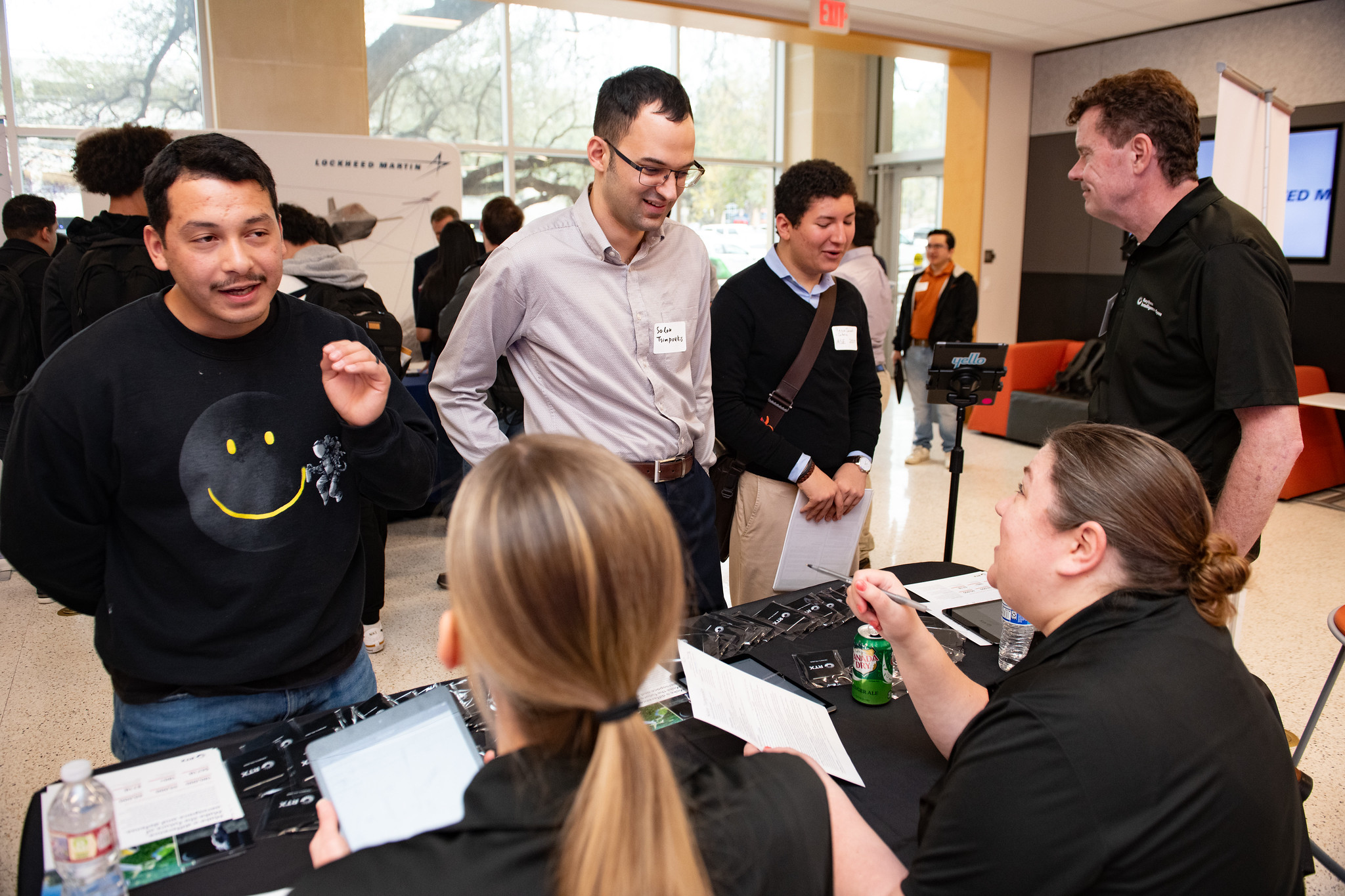 Group of students talking to industry representatives at Industry Open House event.