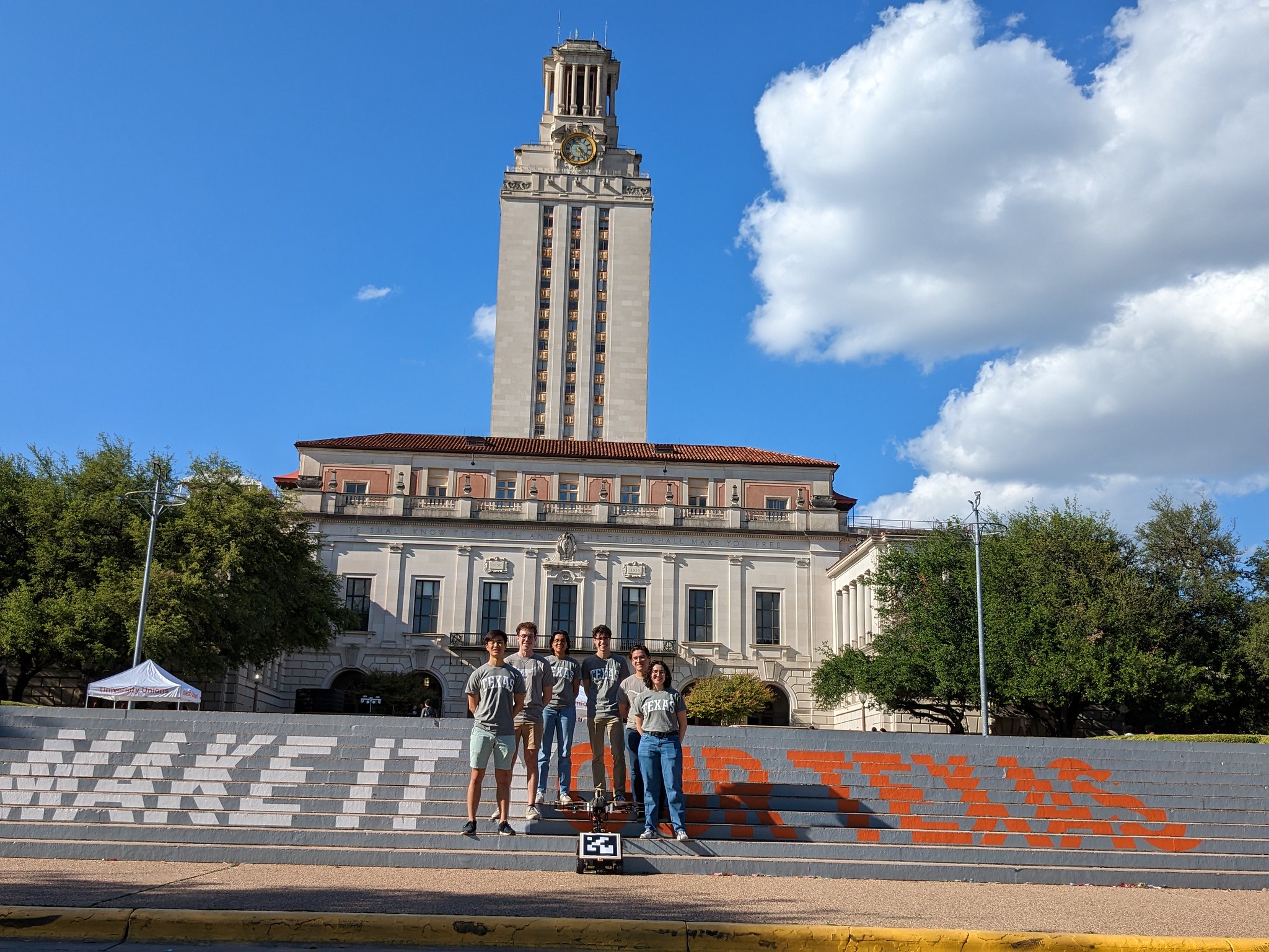 Students standing underneath UT Tower on UT Austin campus.