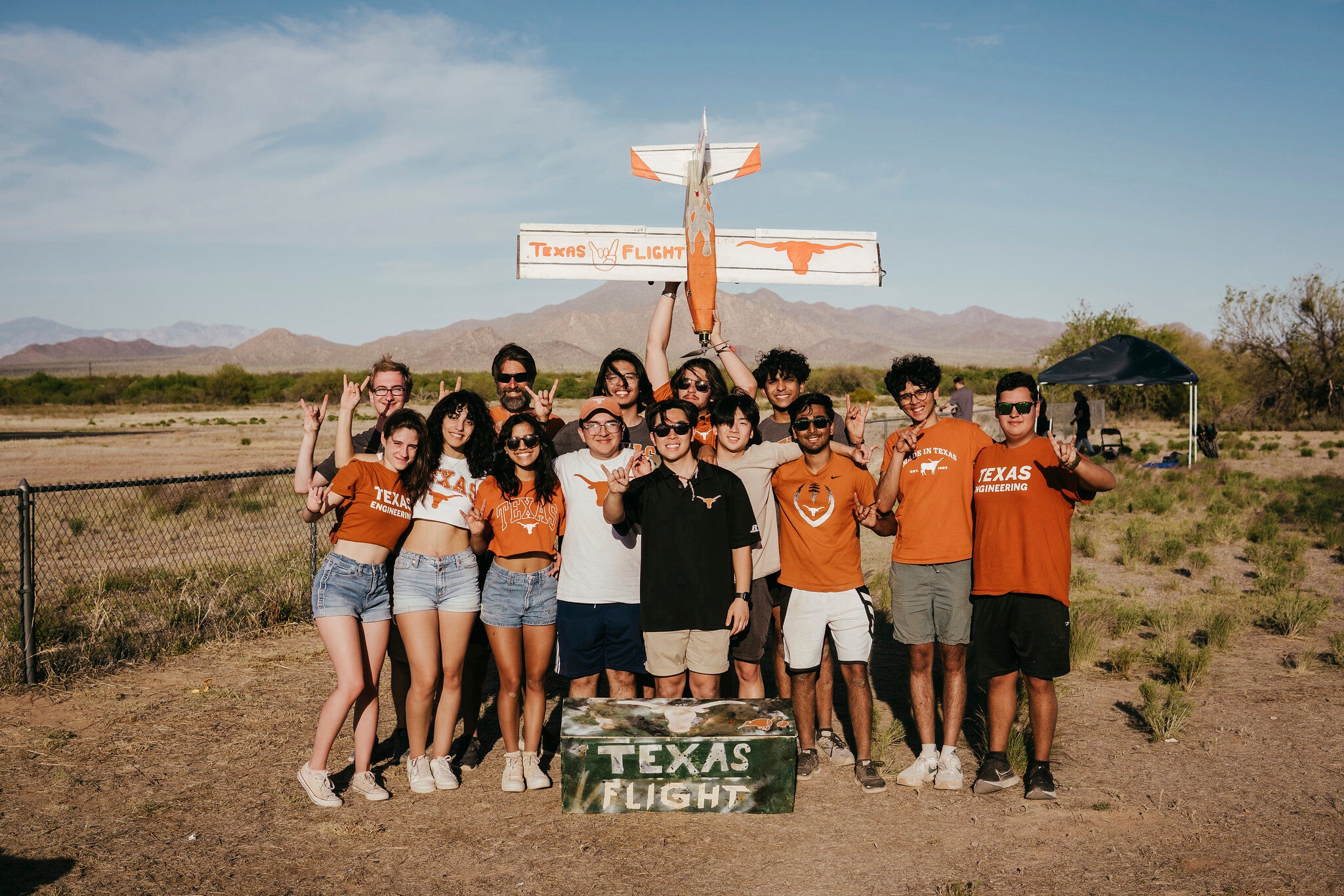 Design Build Fly students smiling with small aircraft