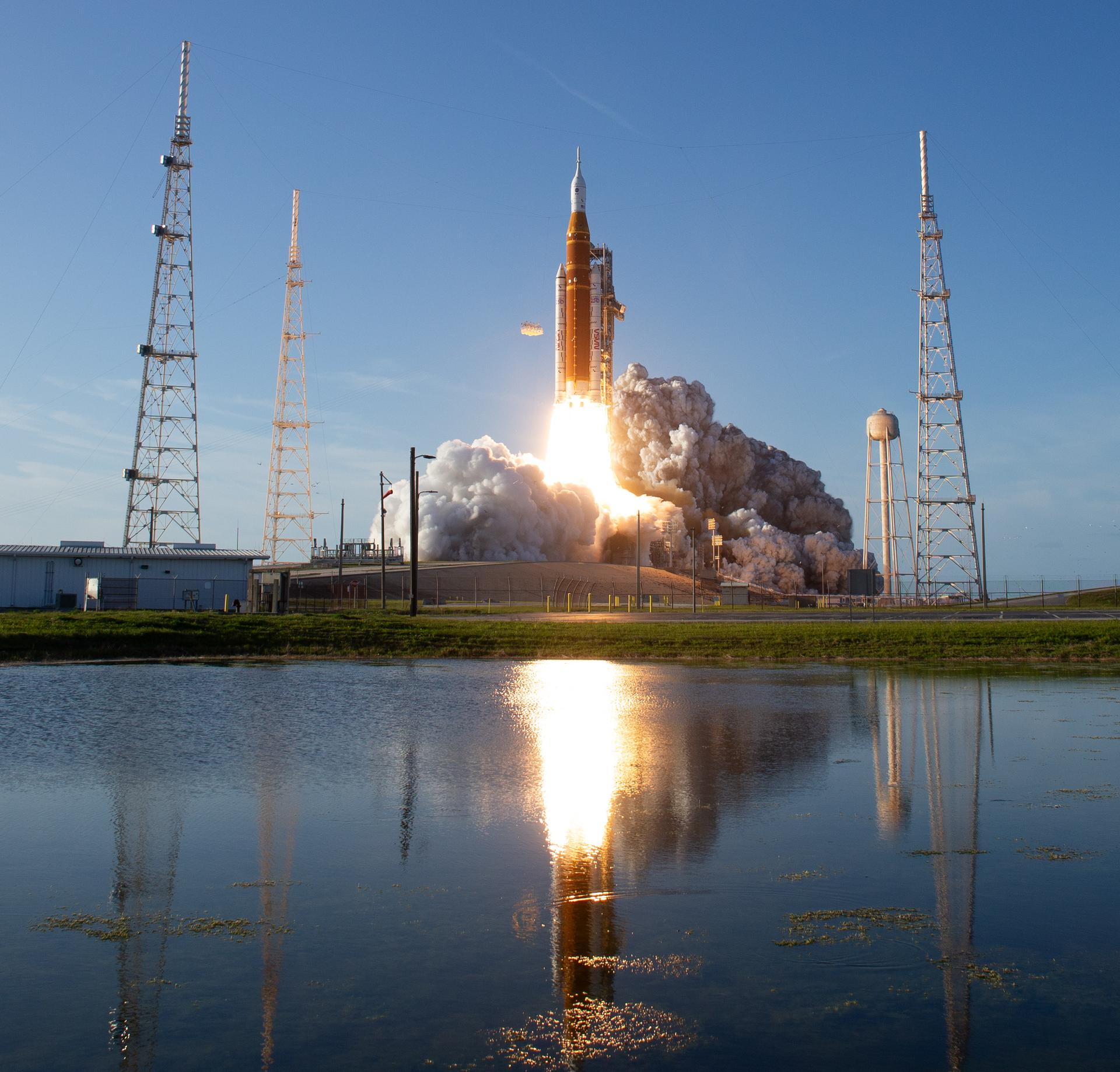 Artemis II rocket launching view from small body of water