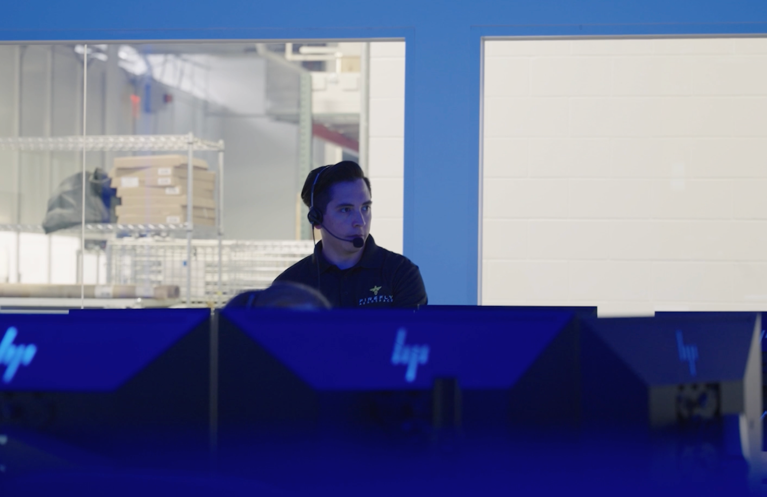 Jesus Charles with headset on at Mission Control for Firefly mission