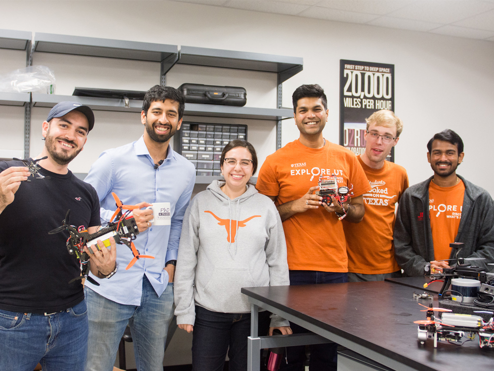 University of Texas graduate students holding drones in lab