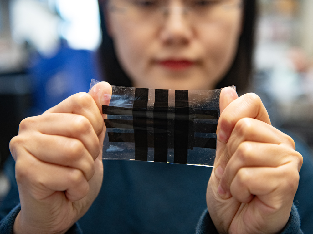 Nanshu Lu holding e-skin prototype